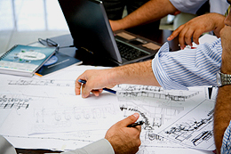 engineering team meeting over blueprints